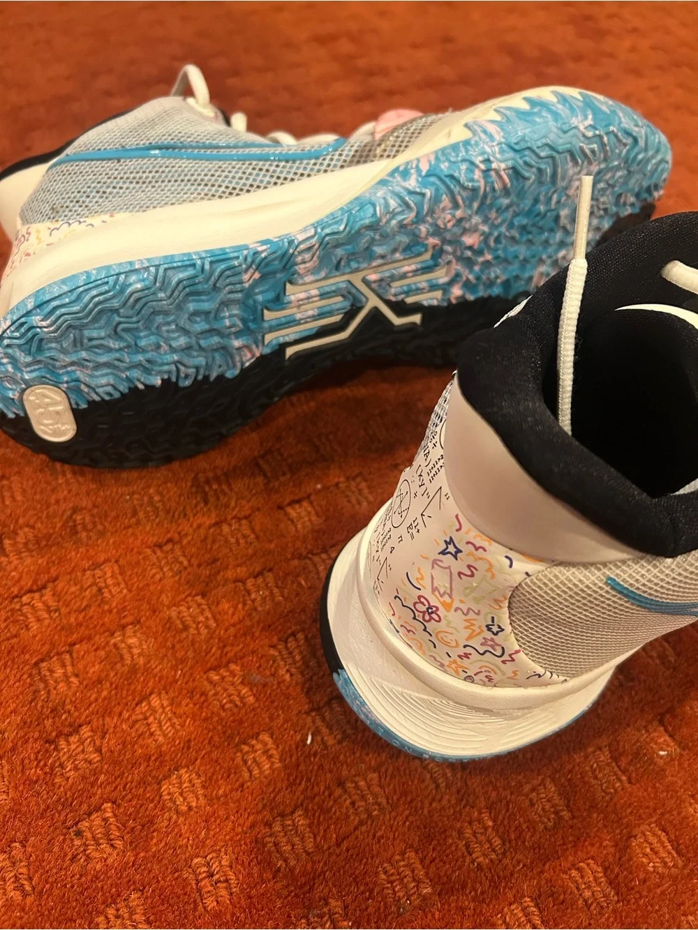 Nike Men’s  KyrieWhite Sneakers with Pink and Light Blue Accents